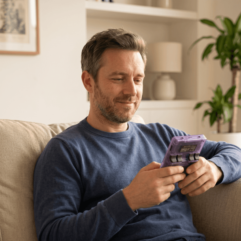 Person playing the HeyShapely Pro 2.0 R36S retro gaming console at home